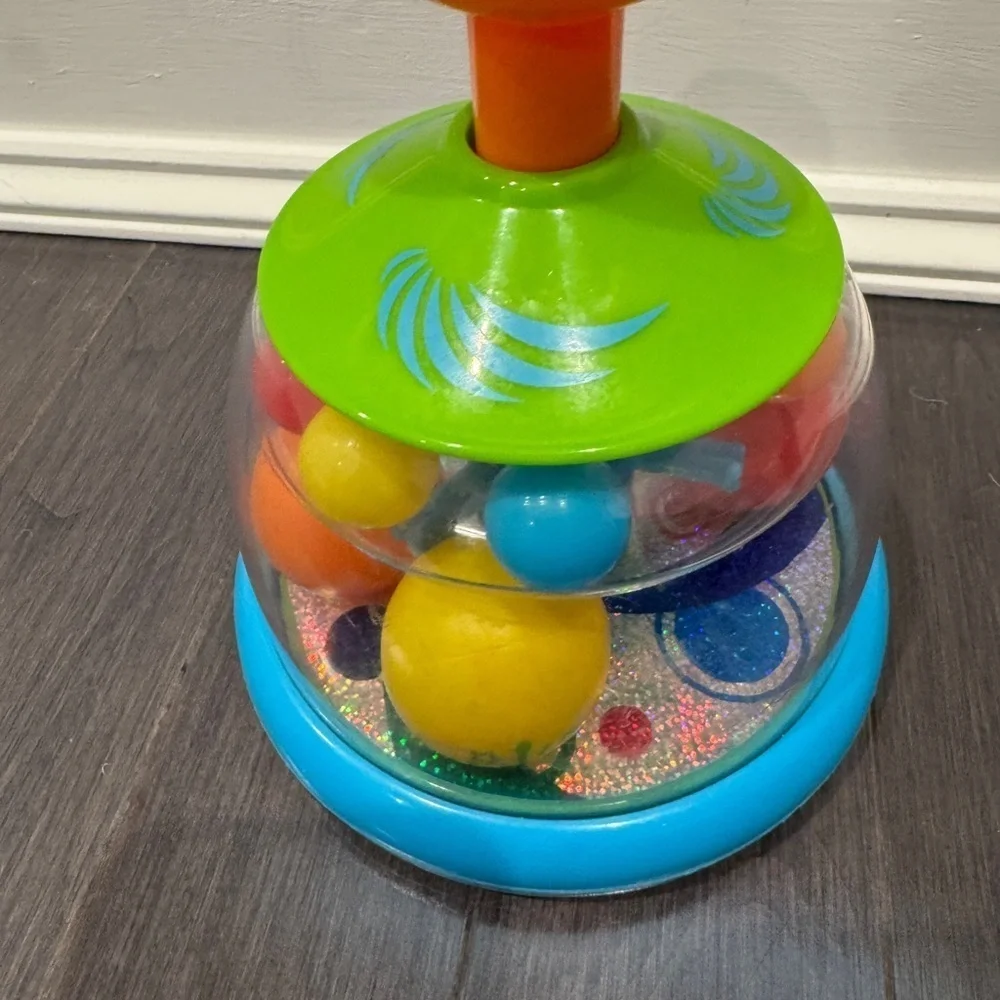 Orange and Green Press and Spin Learning Baby Toy
